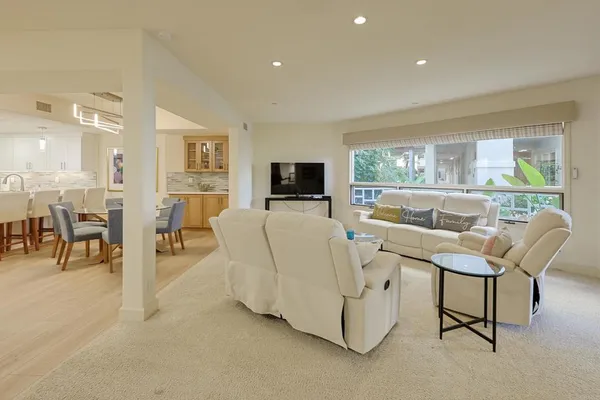a large kitchen with stainless steel appliances a large counter top