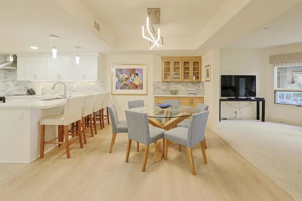 a kitchen with granite countertop white cabinets and stainless steel appliances