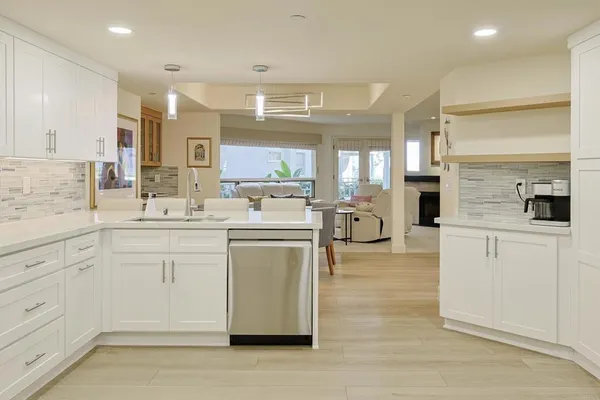 a bedroom with a bed couch and windows