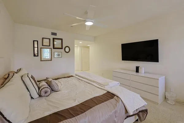 a spacious bedroom with two beds and a window