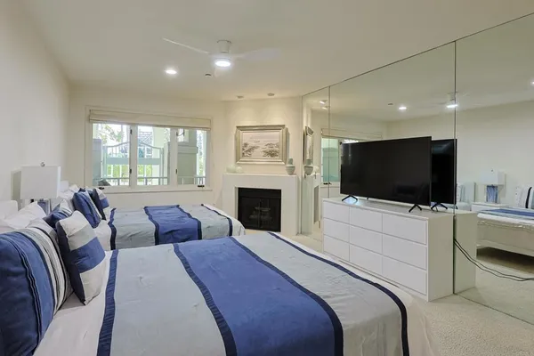 a spacious bedroom with a bed and a chandelier