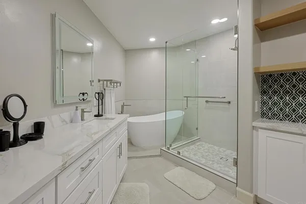 a bathroom with a sink a toilet and shower