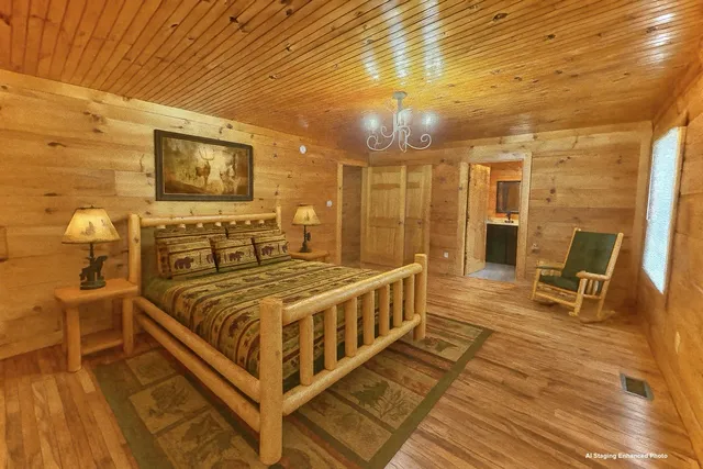 a spacious bedroom with a bed and wooden floor