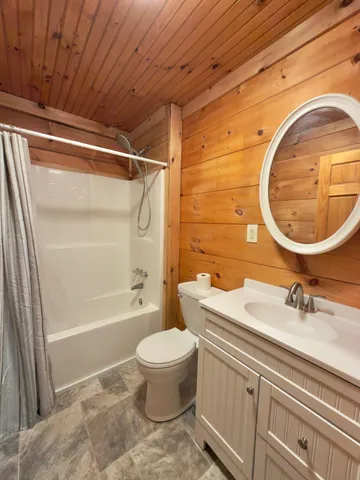 a bathroom with a tub sink and mirror