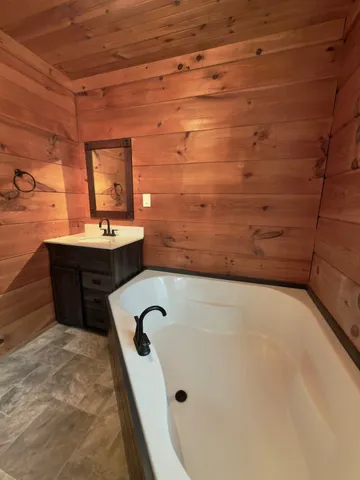 a bathroom with a bathtub and window