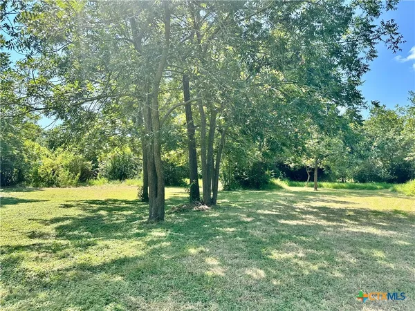 a view of outdoor space with trees all around
