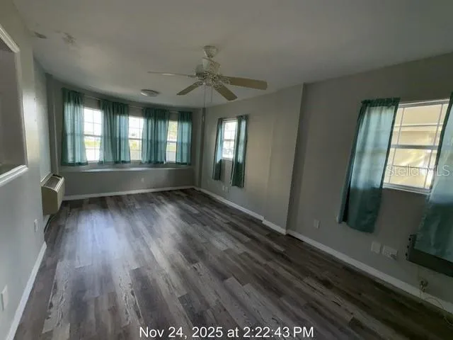 wooden floor in an empty room with a window