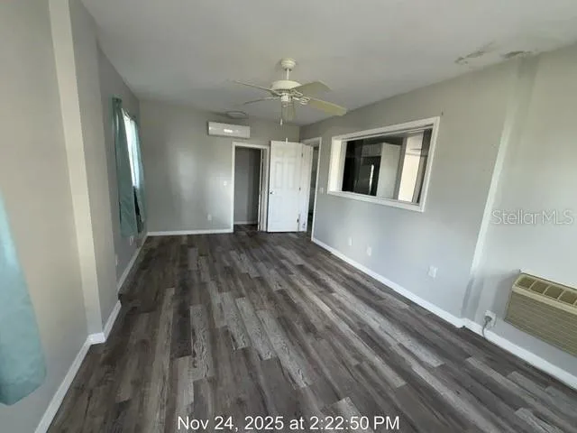 a view of a livingroom with wooden floor and staircase