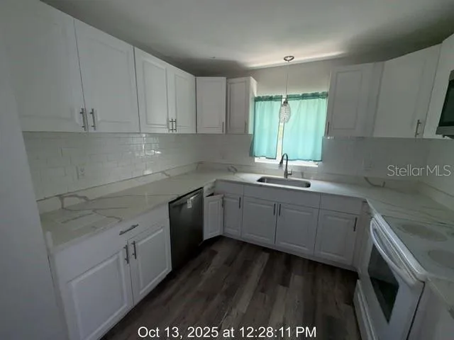 a kitchen with sink cabinets and window