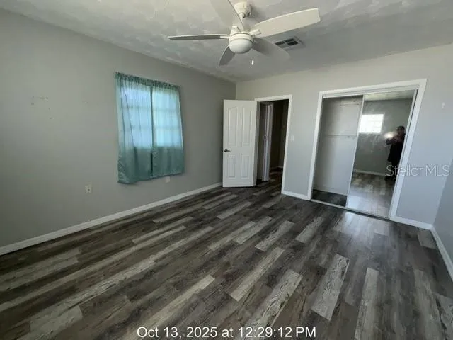 wooden floor in an empty room with a window