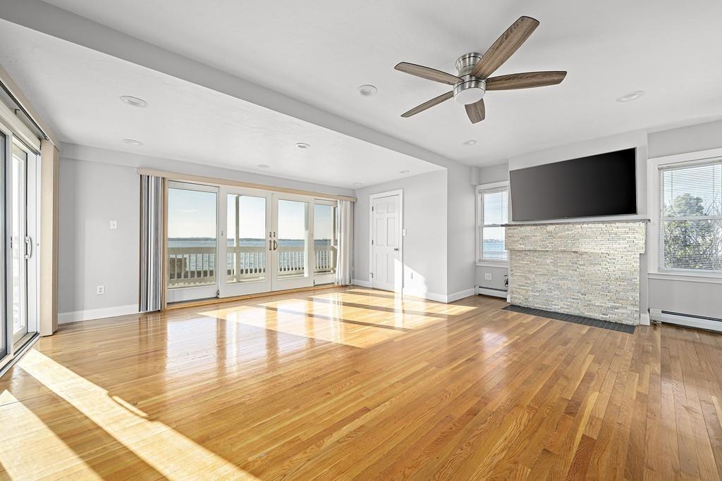 33 Fort Point Road Weymouth, MA 02191 - Photo 13 of 41 a view of a livingroom with wooden floor and a ceiling fan