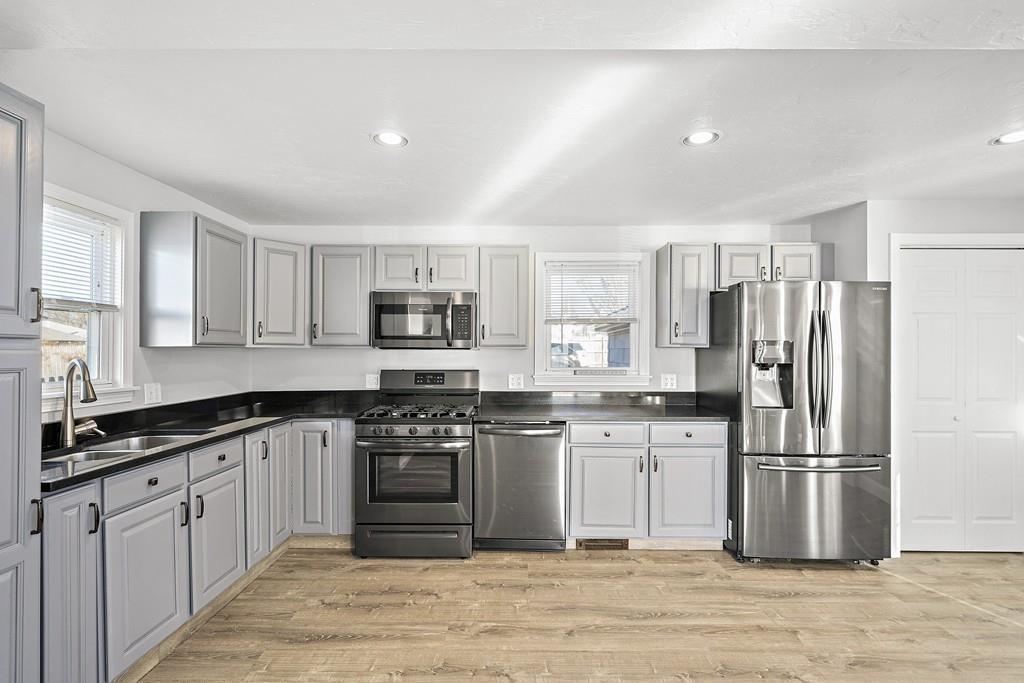 33 Fort Point Road Weymouth, MA 02191 - Photo 5 of 41 a kitchen with stainless steel appliances granite countertop a stove top oven a refrigerator and a sink