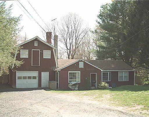 121 Westport Road Wilton, CT 06897 - Photo 1 of 1 a front view of a house with a yard