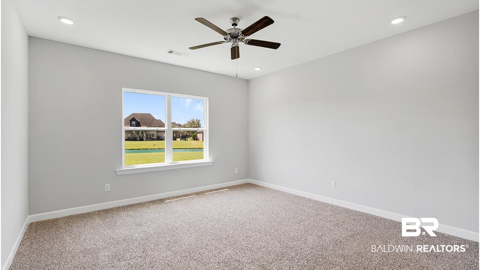 30567 Asheville Road Daphne, AL 36527 - Photo 12 of 29 Empty room with carpet flooring, recessed lighting, a ceiling fan, and a water view