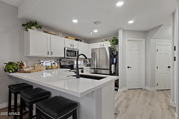 a large white kitchen with a large window