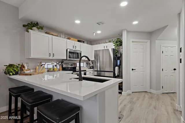 a large white kitchen with a large window