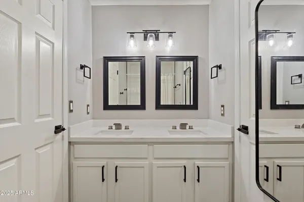 a bathroom with a bathtub a window and a shower