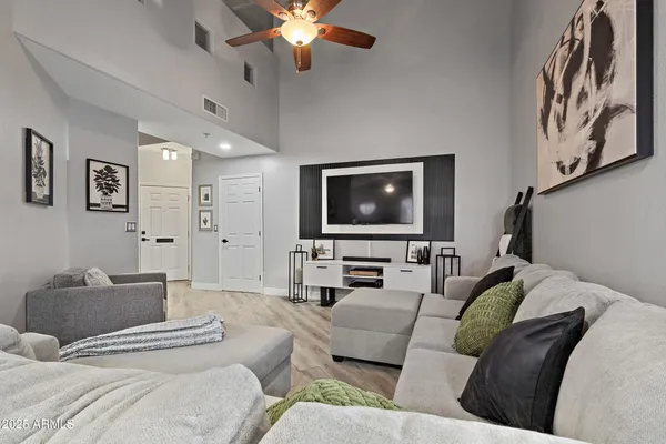 a living room with furniture and a wooden floor