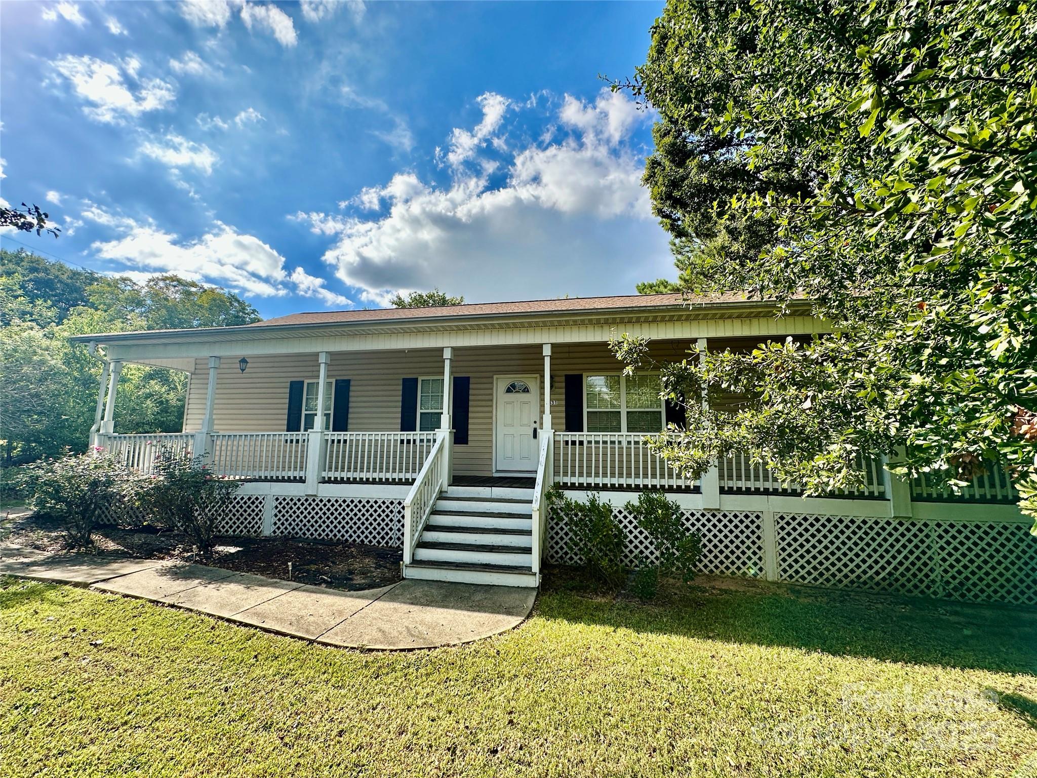 3331 Robinwood Road Gastonia, NC 28054 - Photo 2 of 14 a front view of a house with a garden
