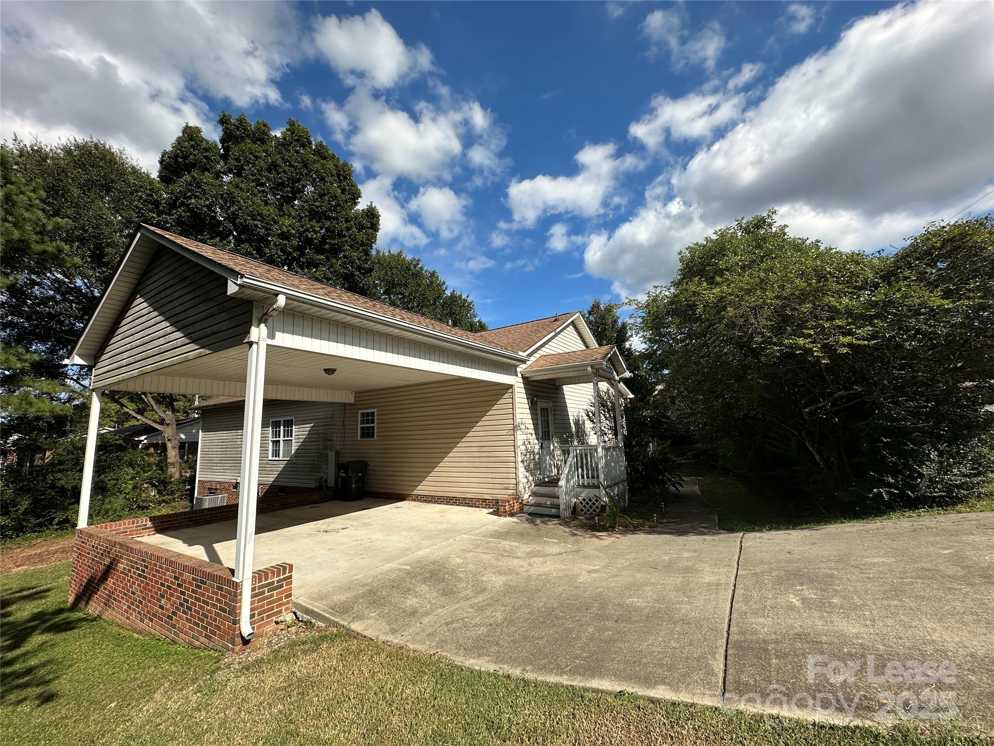 3331 Robinwood Road Gastonia, NC 28054 - Photo 3 of 14 a view of a wooden house with a yard