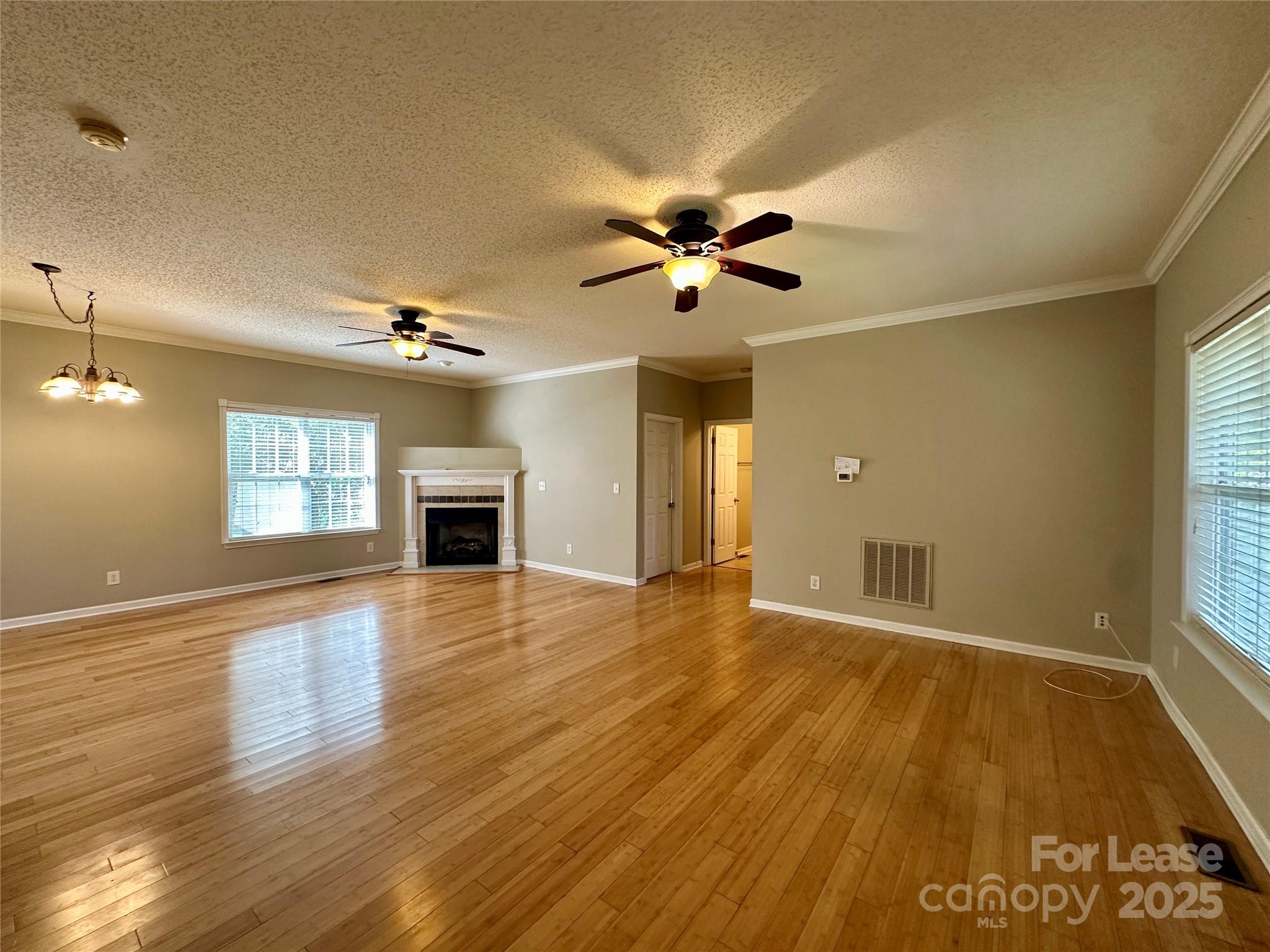 3331 Robinwood Road Gastonia, NC 28054 - Photo 4 of 14 a view of an empty room with a window and wooden floor