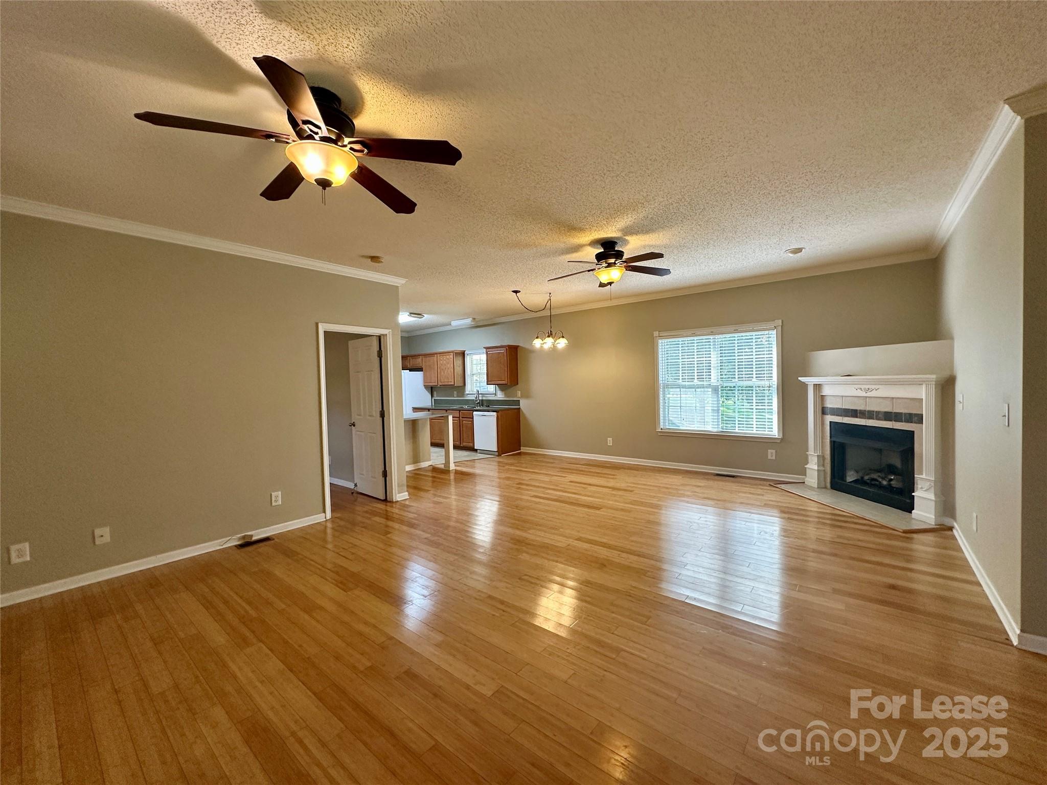 3331 Robinwood Road Gastonia, NC 28054 - Photo 5 of 14 a view of an empty room with wooden floor fireplace and a window