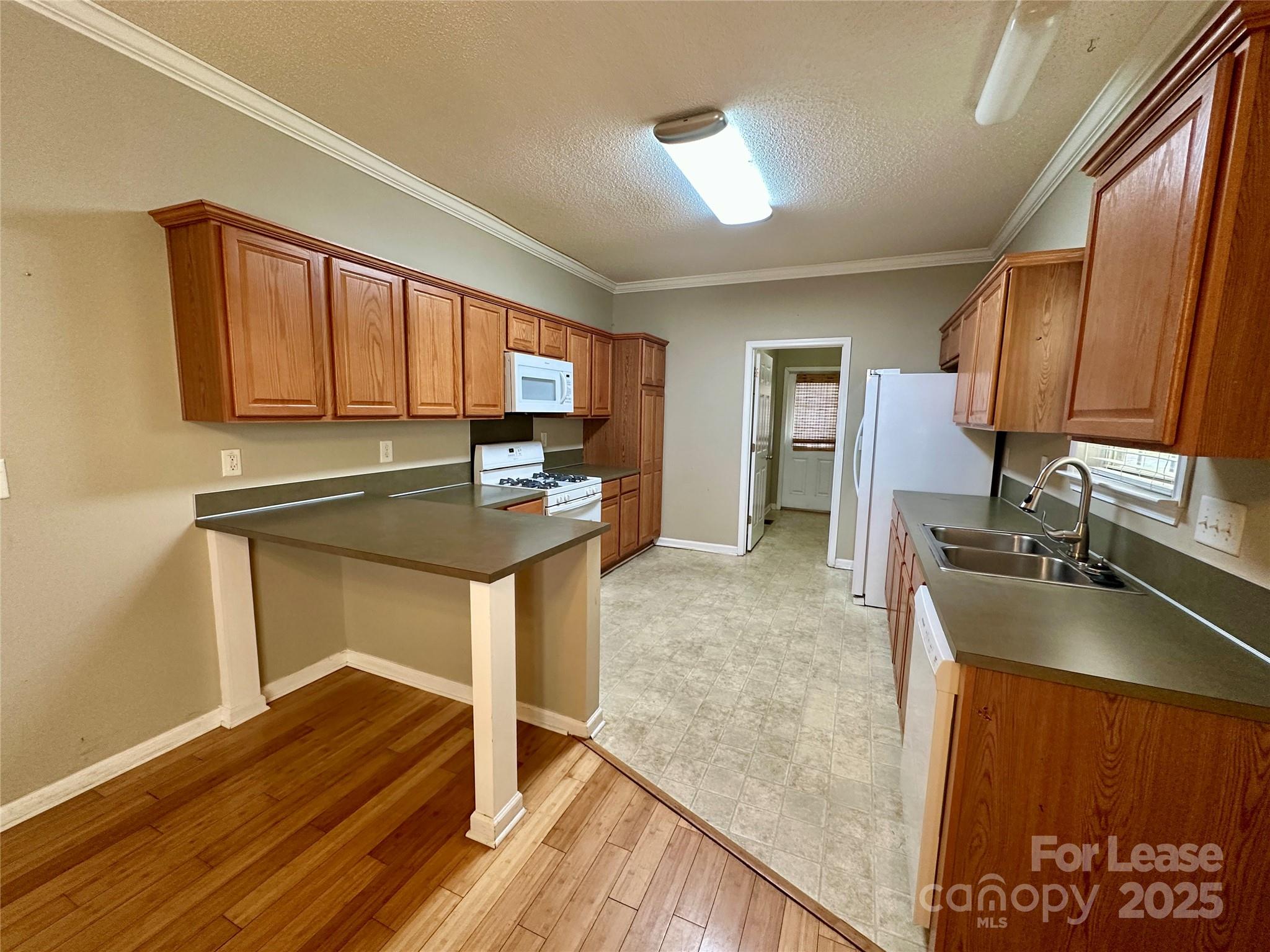3331 Robinwood Road Gastonia, NC 28054 - Photo 6 of 14 a kitchen with granite countertop a sink stove and refrigerator