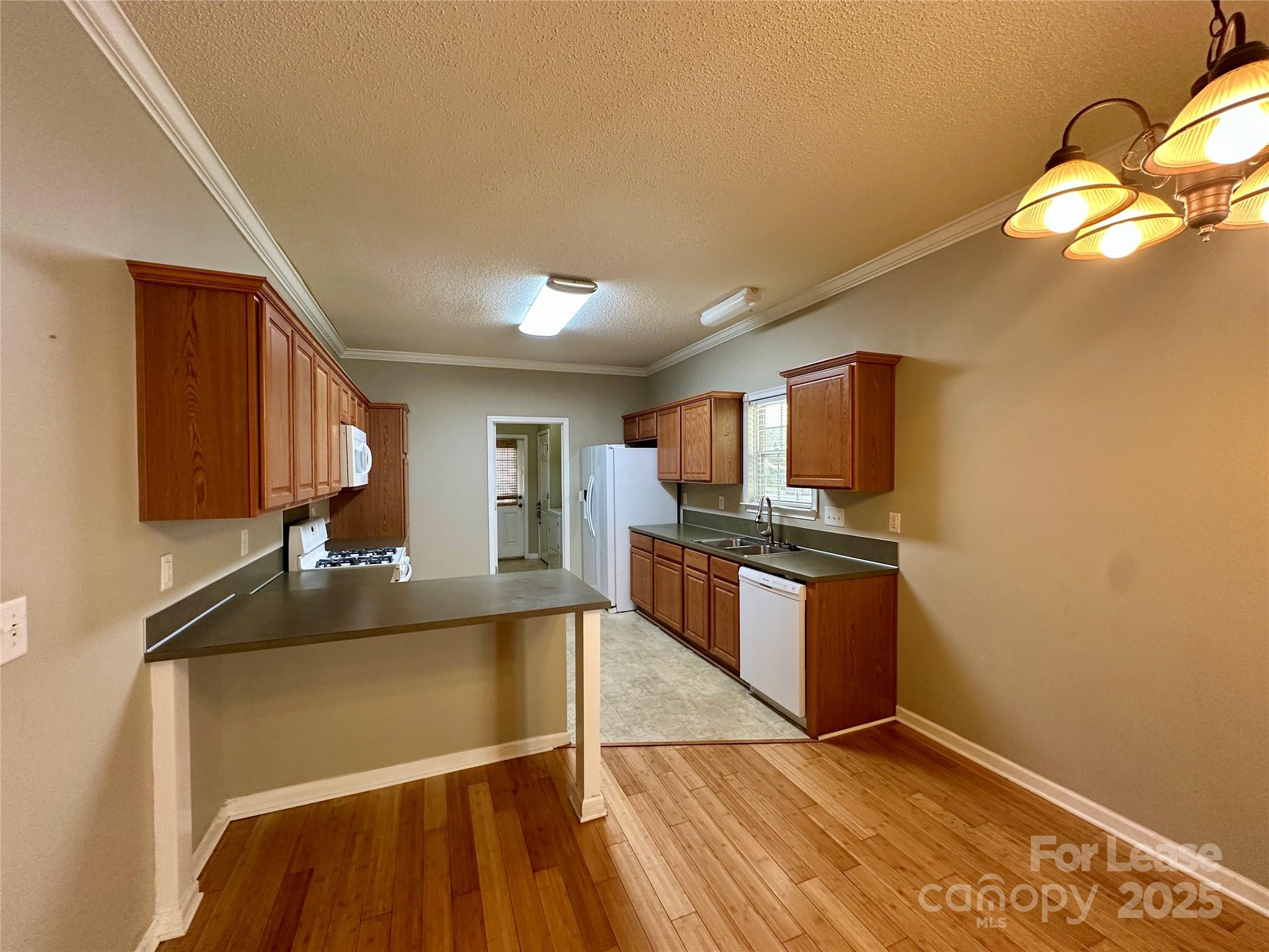 3331 Robinwood Road Gastonia, NC 28054 - Photo 7 of 14 a kitchen with stainless steel appliances granite countertop a refrigerator a sink dishwasher a stove with wooden floor