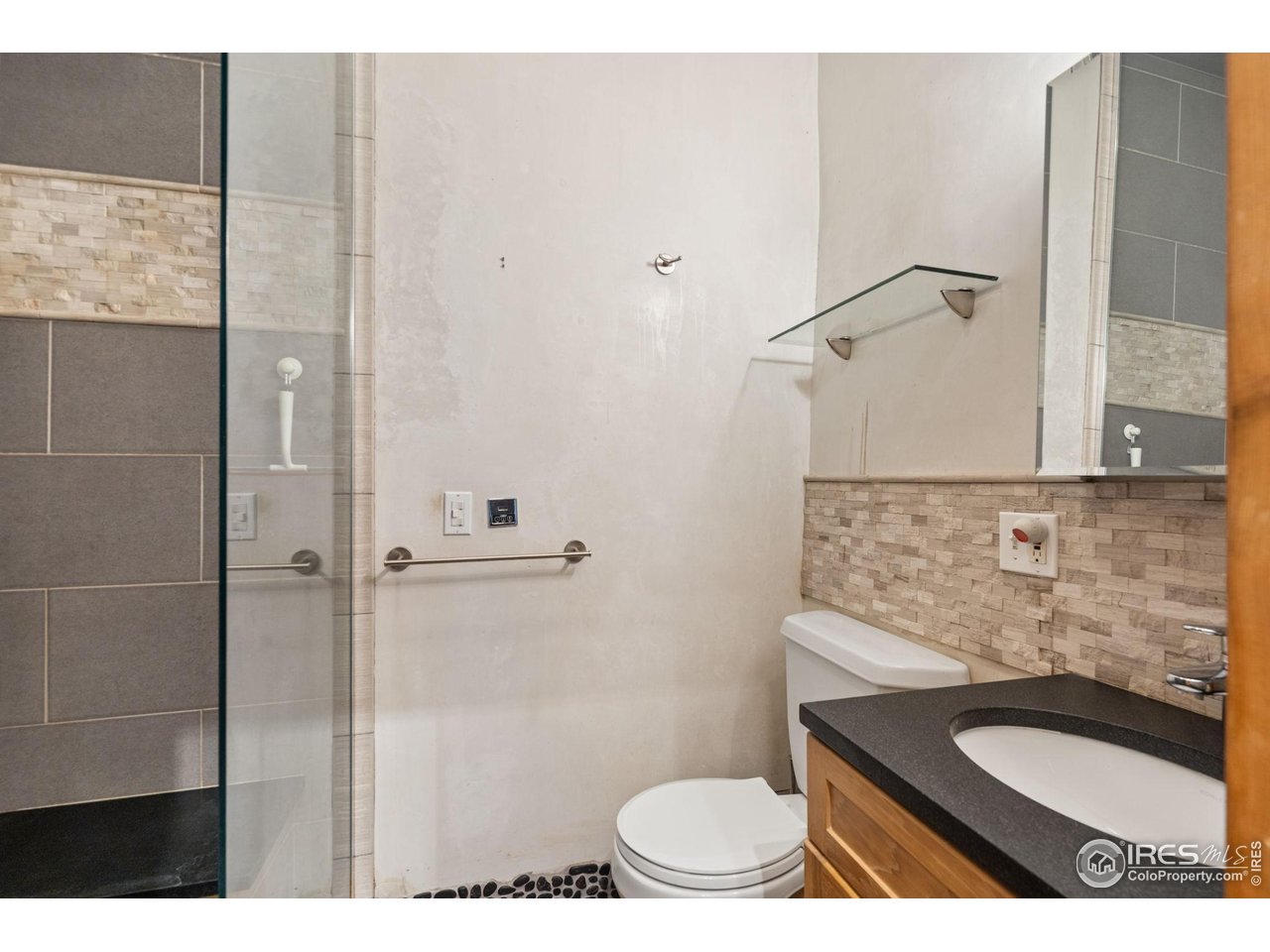1000 Alaska Road Boulder, CO 80302 - Photo 30 of 50 a bathroom with a granite countertop sink a toilet and shower