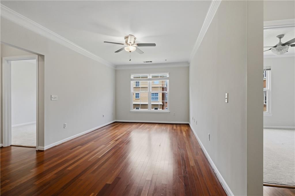 10 Perimeter Summit Boulevard, Unit 3311 Atlanta, GA 30319 - Photo 60 of 68 an empty room with wooden floor chandelier fan and windows