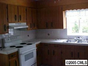 1151 Dunlap Roddey Road Rock Hill, SC 29730 - Photo 2 of 8 a kitchen with a sink a stove a refrigerator and cabinets