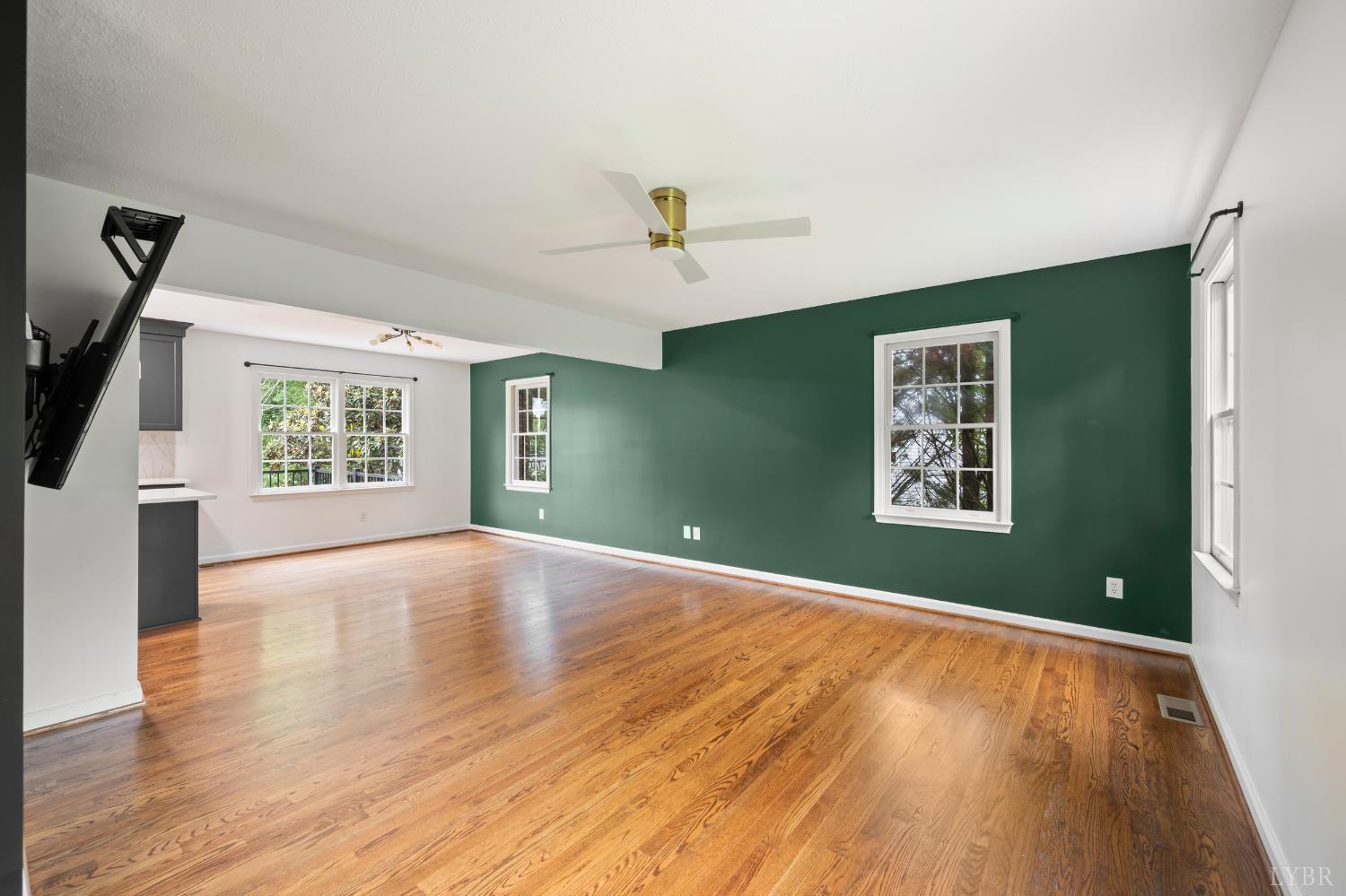 2002 Weatherhill Road Forest, VA 24551 - Photo 9 of 11 an empty room with wooden floor ceiling fan and windows