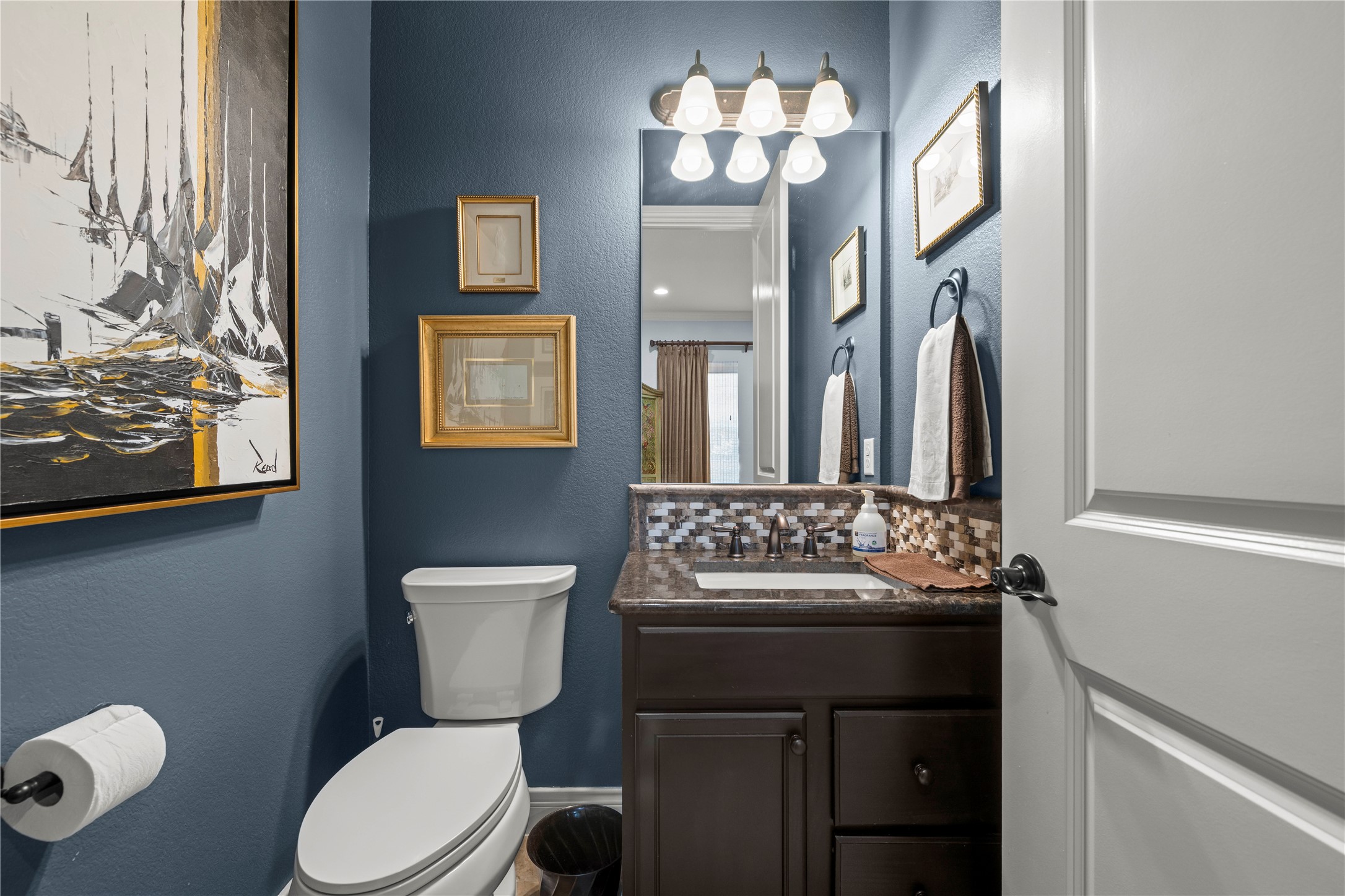 204 Adams Street Georgetown, TX 78628 - Photo 12 of 33 A well-appointed powder room on the main living floor is perfect for guests.