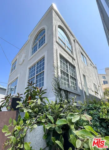 a front view of a building with potted plants