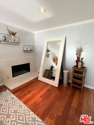 a living room with furniture a flat screen tv and kitchen view