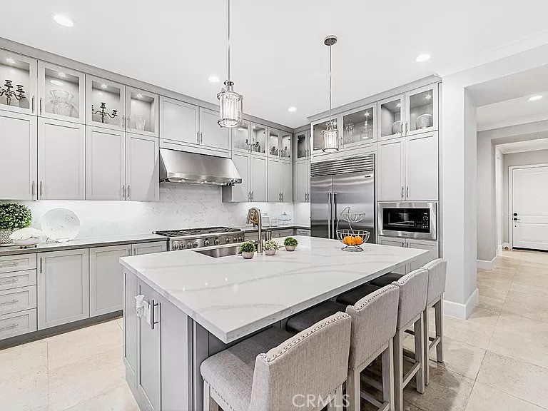 65 Rockinghorse Irvine, CA 92602 - Photo 14 of 45 a kitchen with a stove a kitchen island and a refrigerator