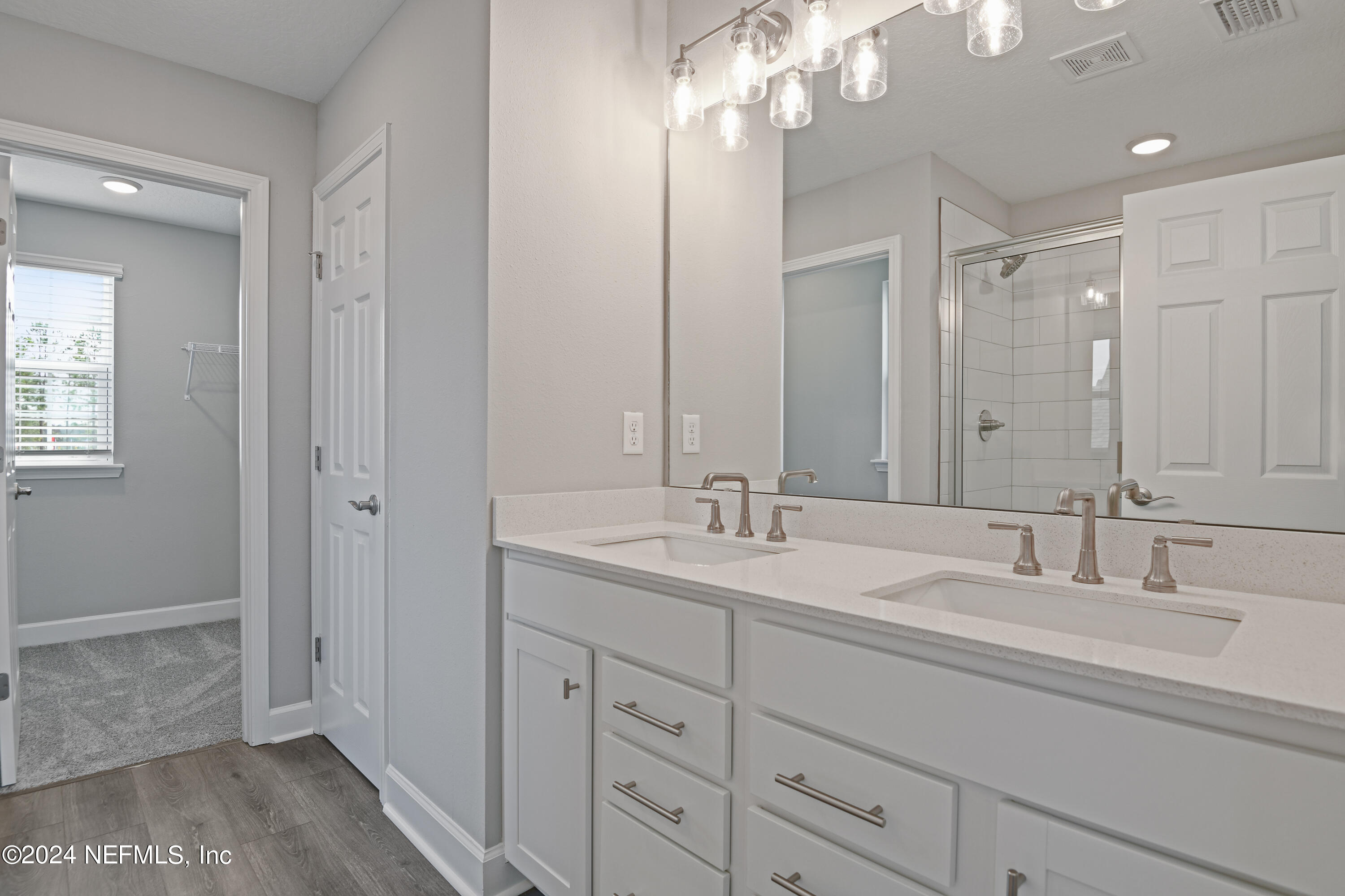 29 Cedar Elm Way St. Augustine, FL 32092 - Photo 15 of 28 a bathroom with double vanity sinks and a mirror