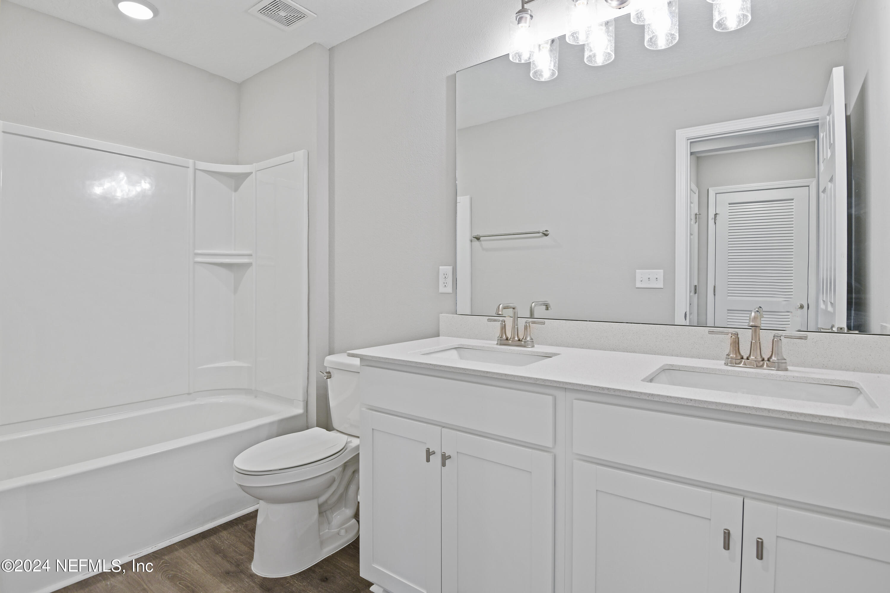 29 Cedar Elm Way St. Augustine, FL 32092 - Photo 16 of 28 a bathroom with a toilet a sink a tub and mirror