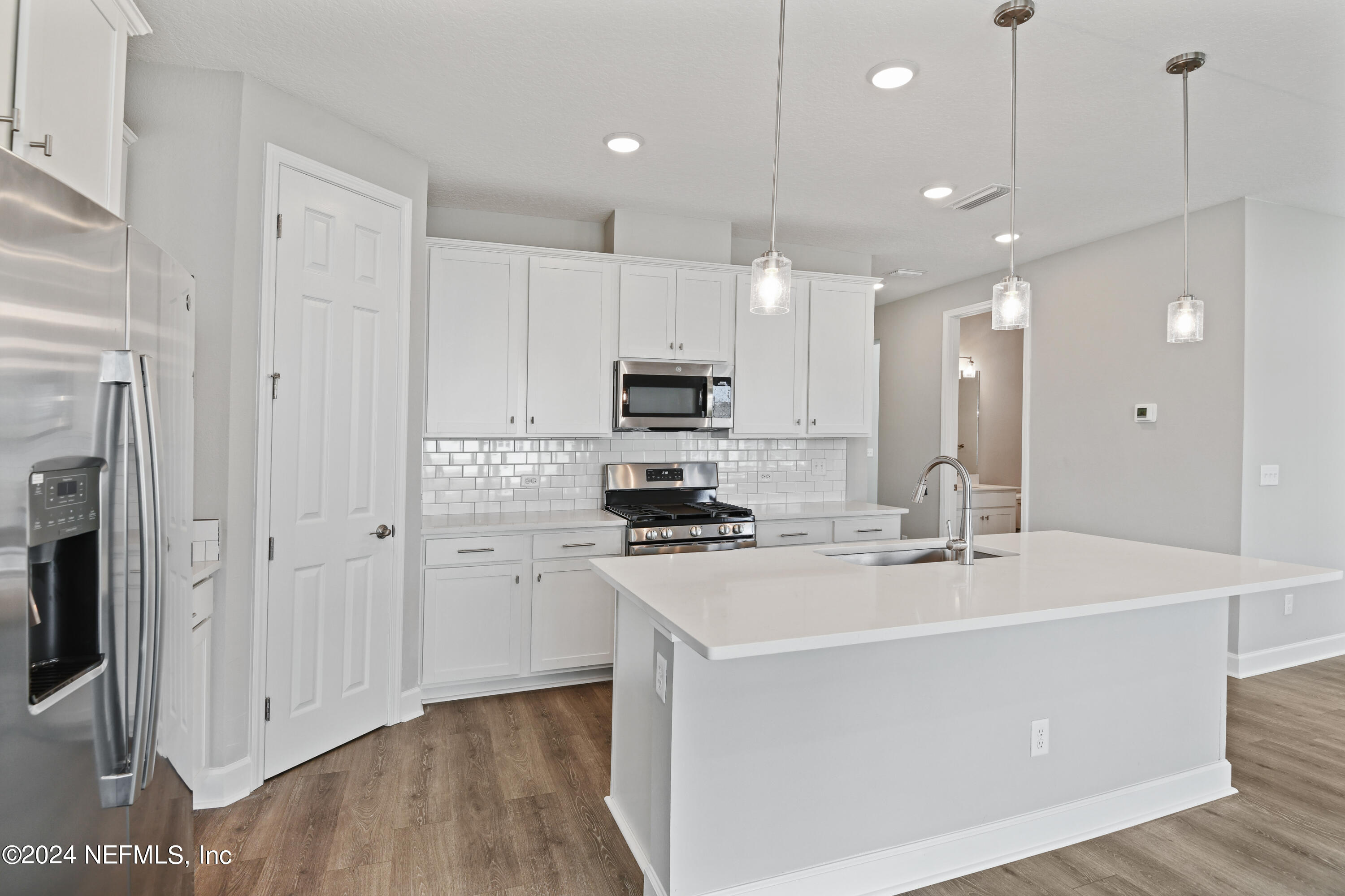 29 Cedar Elm Way St. Augustine, FL 32092 - Photo 3 of 28 a kitchen with kitchen island a sink stainless steel appliances and cabinets