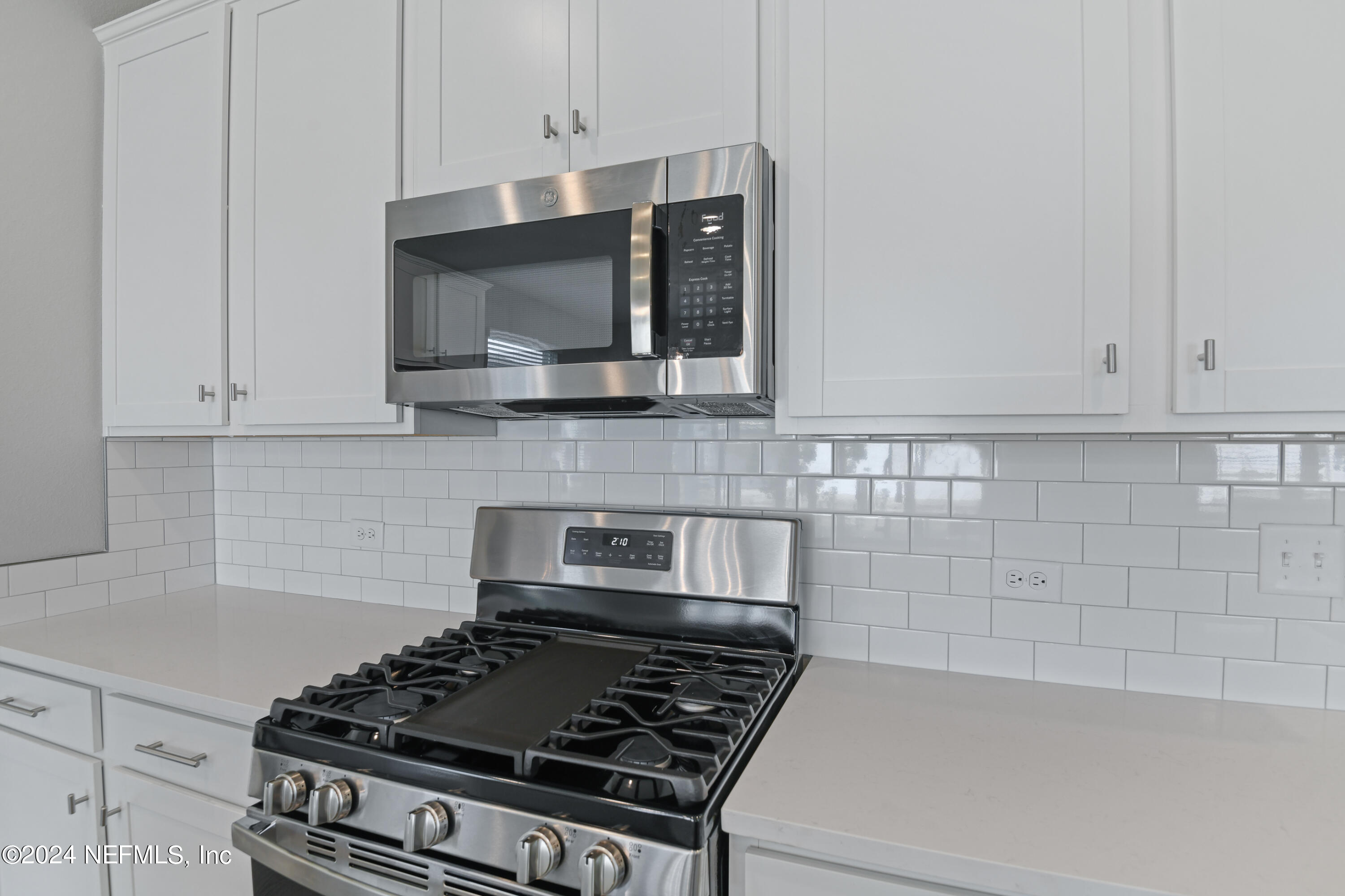 29 Cedar Elm Way St. Augustine, FL 32092 - Photo 6 of 28 a kitchen with stainless steel appliances a stove and white cabinets