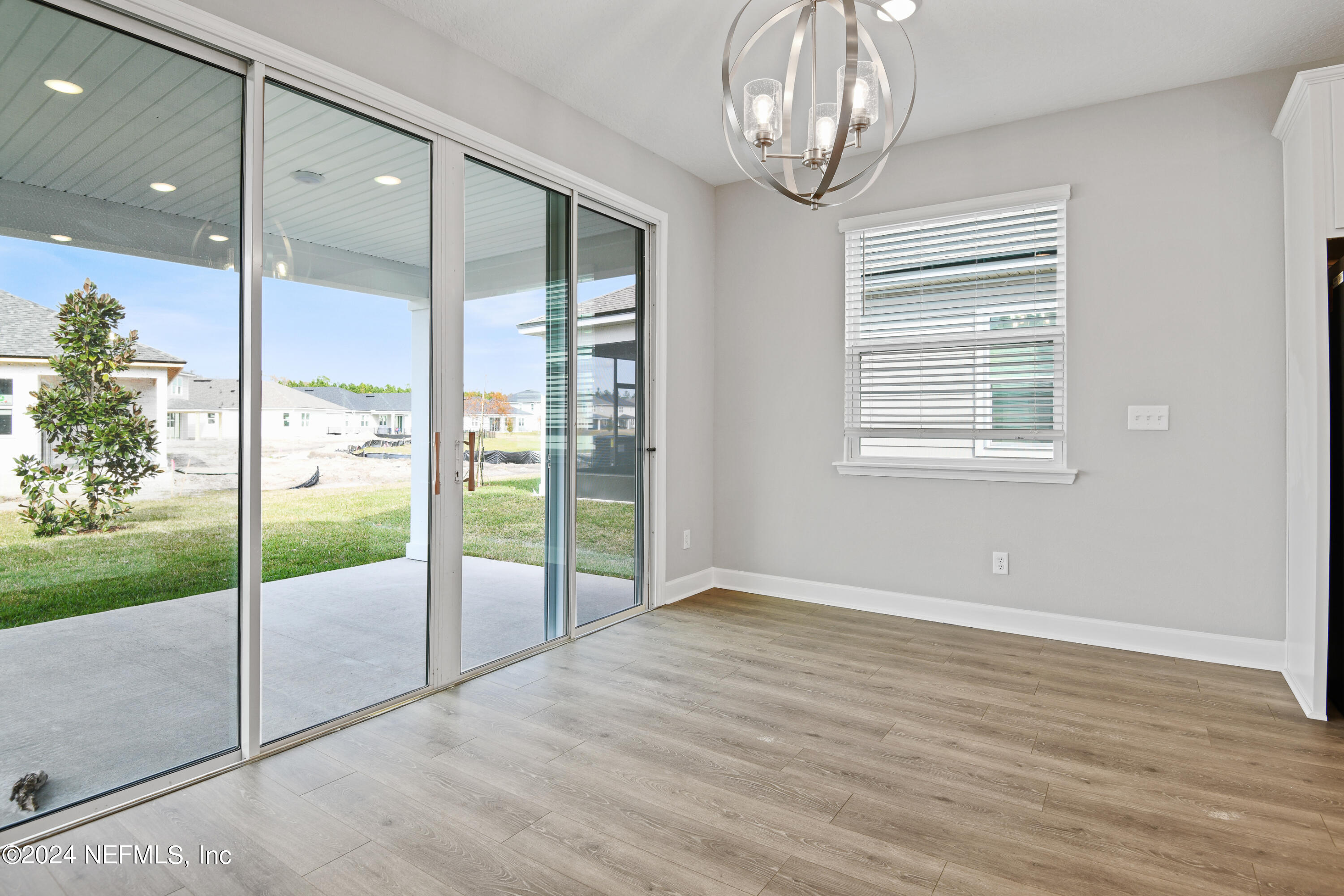 29 Cedar Elm Way St. Augustine, FL 32092 - Photo 7 of 28 an empty room with wooden floor fan and windows