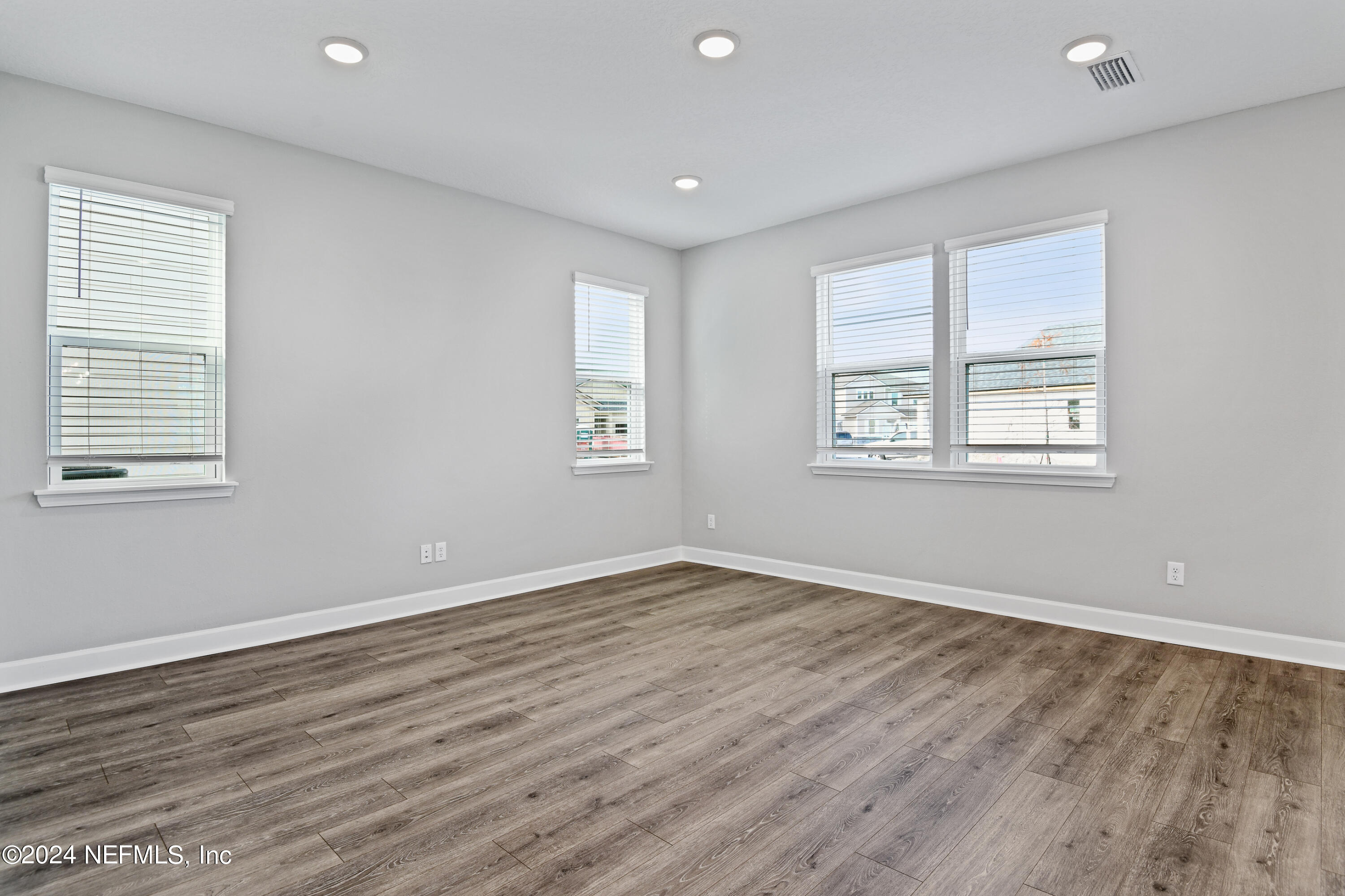 29 Cedar Elm Way St. Augustine, FL 32092 - Photo 8 of 28 a view of an empty room with wooden floor and a window