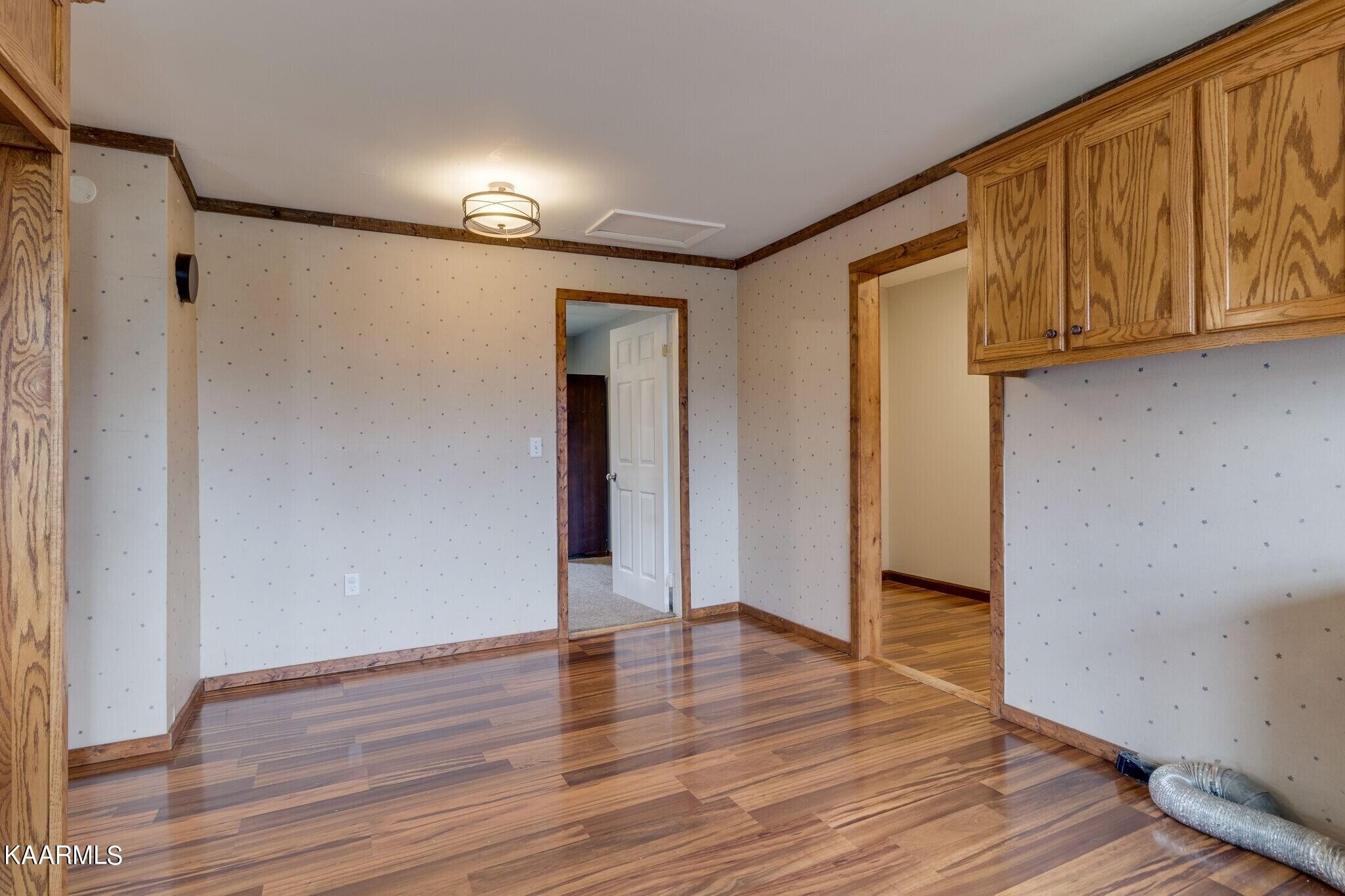 108 Davidson Street Deer Lodge, TN 37726 - Photo 11 of 30 a view of an empty room with wooden floor and a window