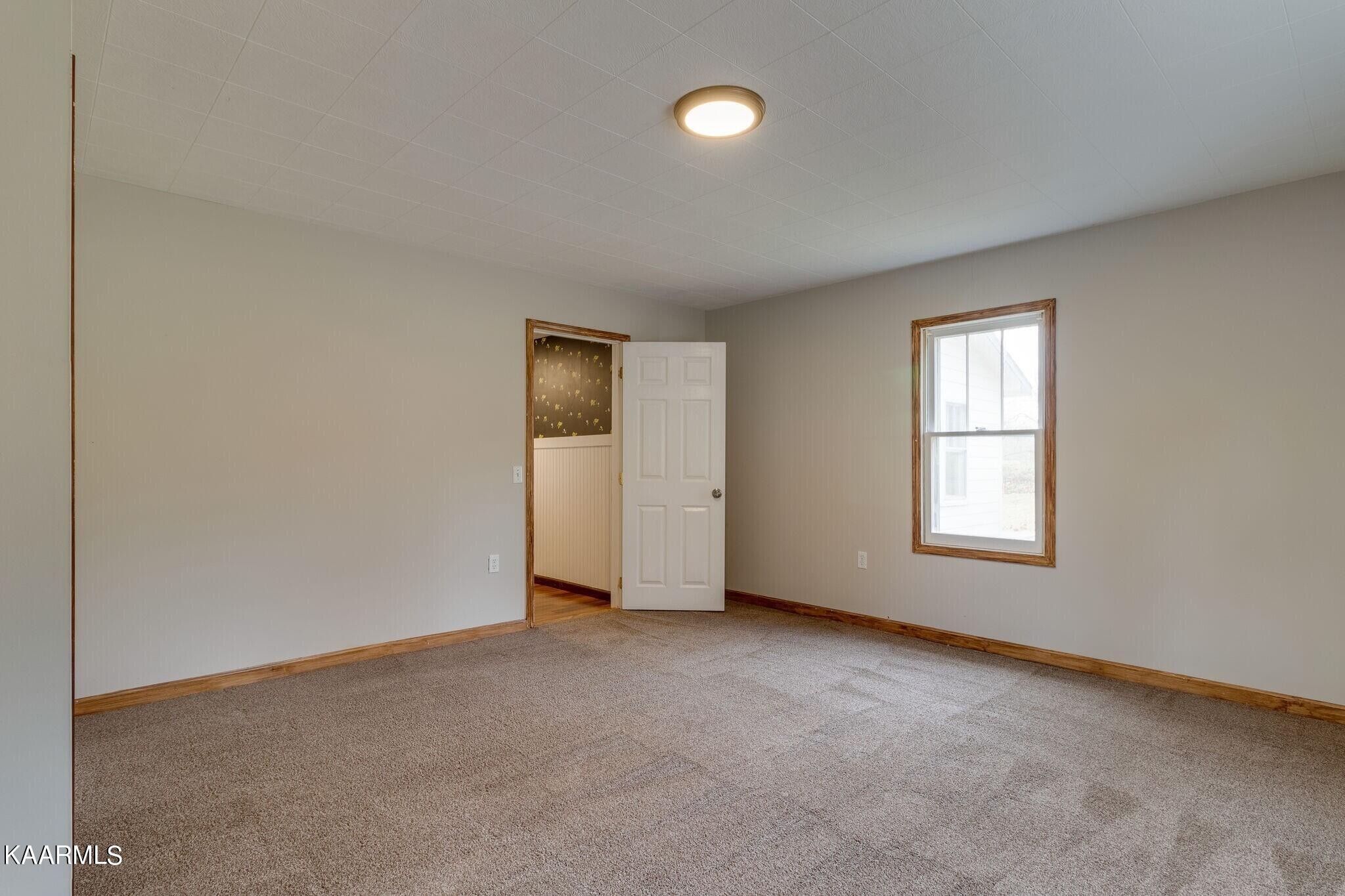 108 Davidson Street Deer Lodge, TN 37726 - Photo 16 of 30 an empty room with windows and closet
