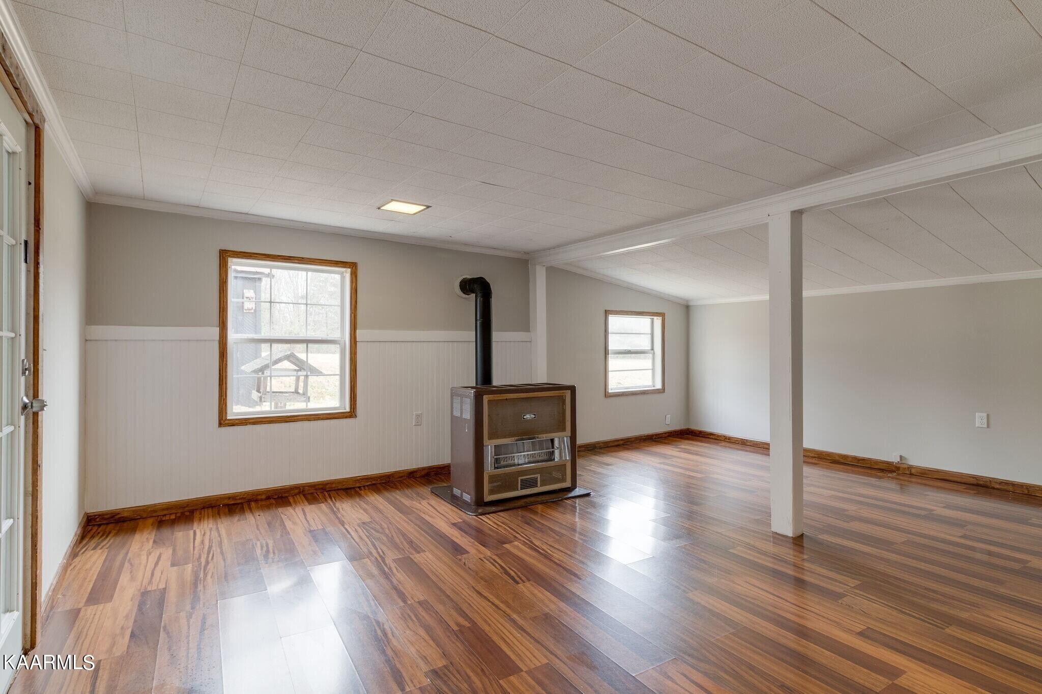 108 Davidson Street Deer Lodge, TN 37726 - Photo 17 of 30 an empty room with wooden floor and windows
