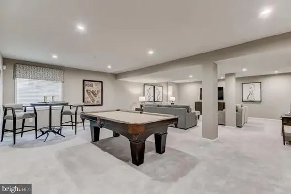 a room with furniture pool table and windows