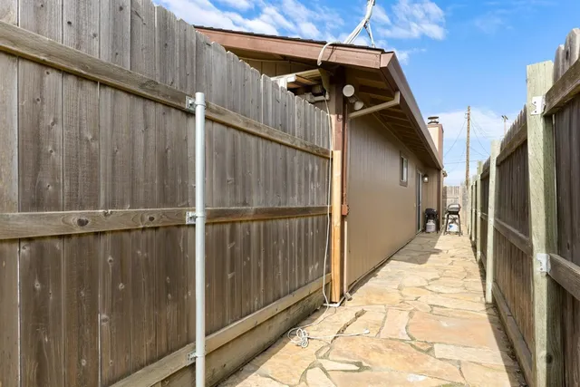 a view of a house with a wooden bench