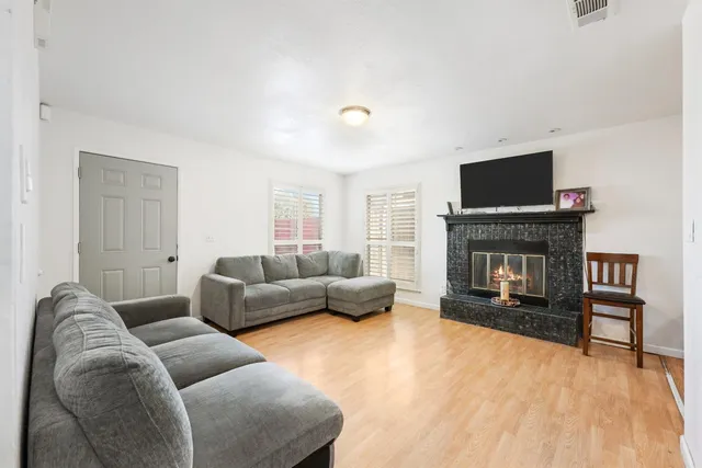 a living room with furniture and a fireplace