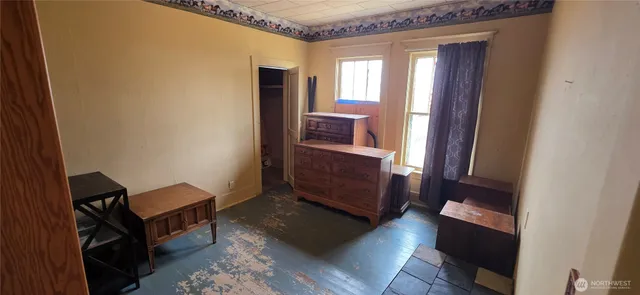 a living room with wooden floor and furniture