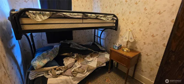 a view of bedroom with furniture and wooden floor